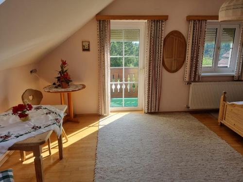 a living room with a table and a window at 2 Person Beedroom at Fam Herbst I Thaller in Wagerberg