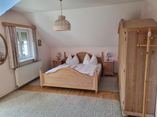 a bedroom with a wooden bed and two night stands at 2 Person Beedroom at Fam Herbst I Thaller in Wagerberg
