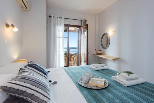 a bedroom with a bed with a plate of food on it at Hotel Barbati Sea View B&B in Barbati