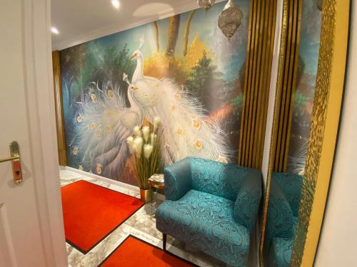 a living room with a peacock painting on the wall at Royal Delux-Klima,Balkon,Lift-Nähe Schönbrunn in Vienna