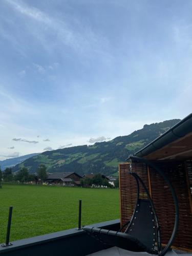 a view of a grassy field from a house at Apart Egger in Schwendau