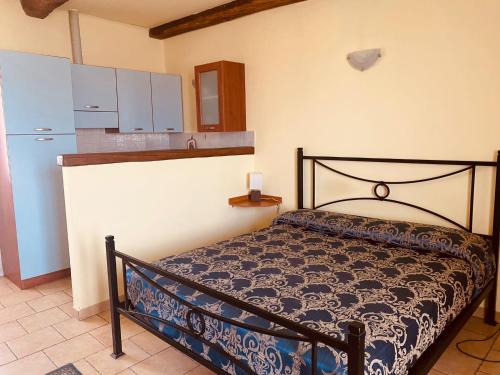 AGRITURISMO CASCINA MONACHE في Santa Vittoria dʼAlba: غرفة نوم صغيرة بها سرير وثلاجة