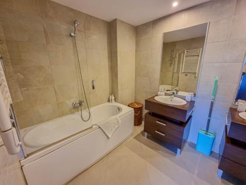 a bathroom with a tub and a sink at Silver Mountain G1 21 R in Poiana Brasov