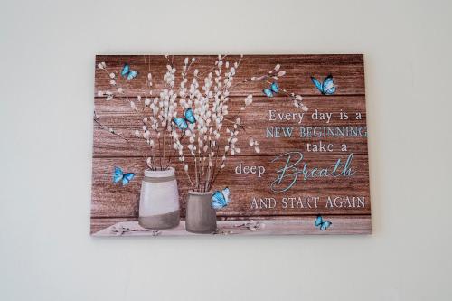 a picture of butterflies on a wooden wall at Entire House-Merseyside-Liverpool in Birkenhead