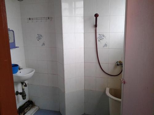 ein Bad mit einer Dusche, einem WC und einem Waschbecken in der Unterkunft HotelMalaya in Taiping