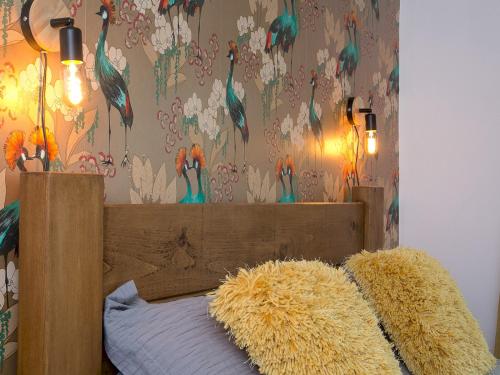 a bedroom with a bed with a flower wallpaper at Pass the Keys Modern Coastal Home in Bull Bay in Amlwch