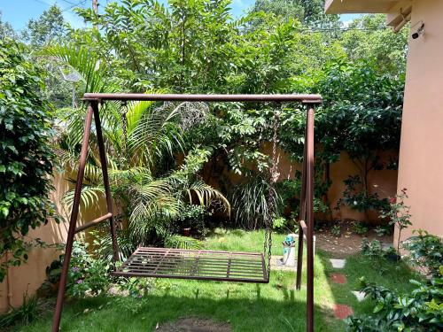 a swing in the grass in a garden at Erisha Tadoba in Mohurli