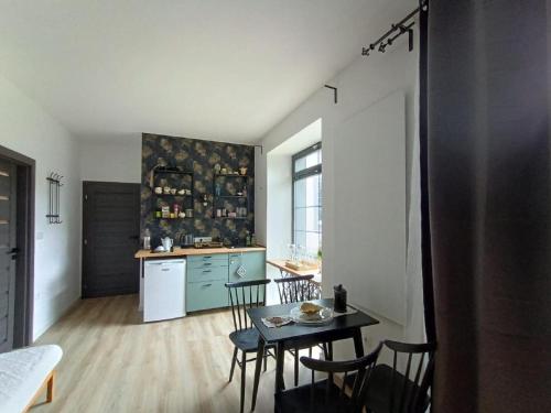 a kitchen with a table and chairs in a room at Apartmány Oxota in Jaroměř
