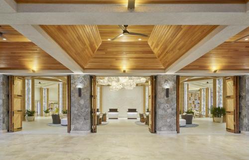 a lobby with a wooden ceiling and a hallway with chairs at The Westin St Thomas Beach Resort & Spa in Frydendal
