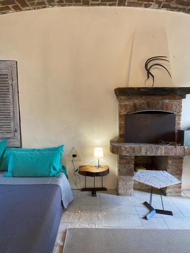 a bedroom with a bed and a fireplace at La Dimora delle Viole in Lauriano