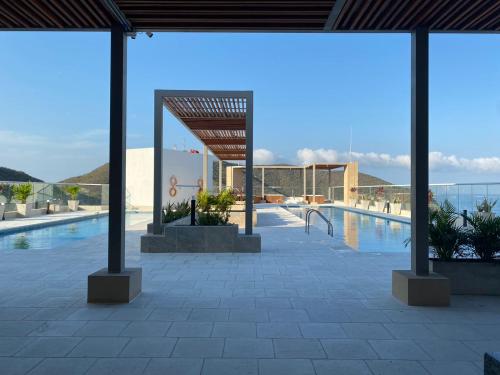 a swimming pool with a view of the ocean at El Samario Cumbia Host-Playa Salguero- Santa Marta in Gaira