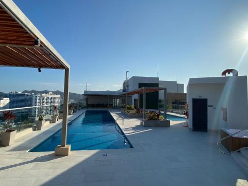 a swimming pool on the roof of a building at El Samario Cumbia Host-Playa Salguero- Santa Marta in Gaira