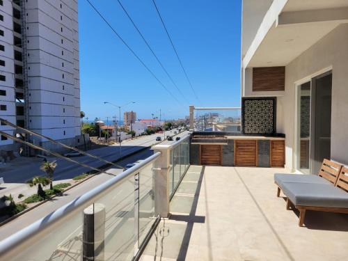 a balcony of a building with a view of a street at Rosarito Beach condominio in Rosarito