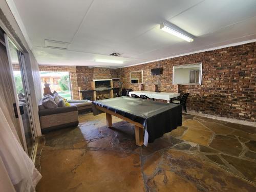 a living room with a ping pong table in it at Midway Overnight Rooms in Kimberley