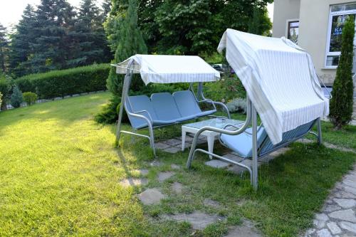 a pair of chairs under a gazebo in a yard at Hotel Duchess in Varna City