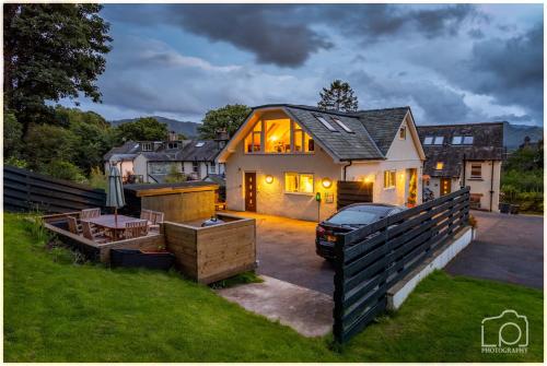 a house with a grill in the yard at Latrigg View in Keswick