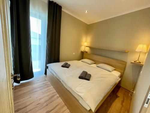 a bedroom with a bed with two pillows on it at Apartmány Lavender 
