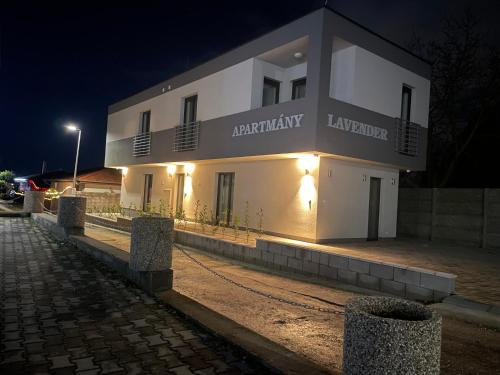 a large white building with lights on it at night at Apartmány Lavender in Nova Dedinka