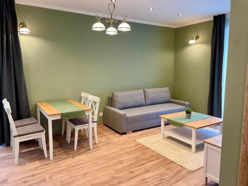 a living room with a couch and a table at Apartmány Lavender in Nova Dedinka