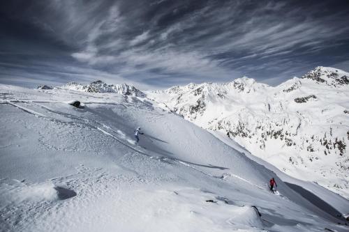 two people skiing down a snow covered mountain at Hotel Andy 4 Sterne Superior in Jerzens