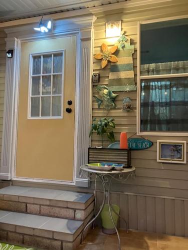 a front door of a house with a table next to it at Coastal Imagination Oasis in Davenport