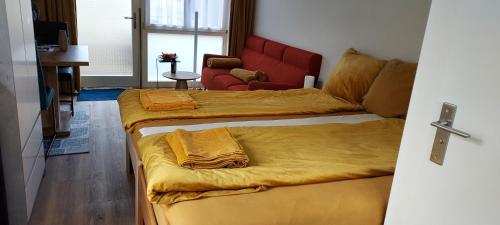 a couple of beds in a room with a couch at Dajan in Almere