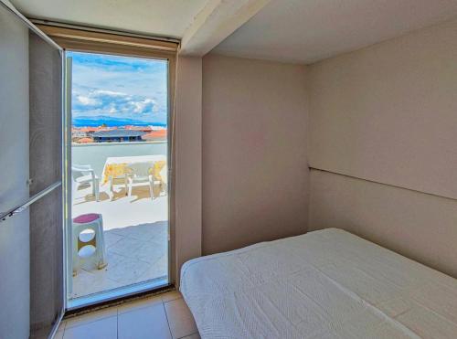 a bedroom with a bed and a window with a view at enjoy in Cesme