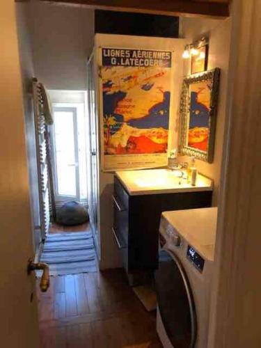 une petite salle de bain avec un lavabo et un miroir dans l'établissement Appartement duplex refait à neuf calme et lumineux, à Paris