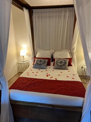 a bed with two pillows on it in a bedroom at La Halte Louis XIII in Bram