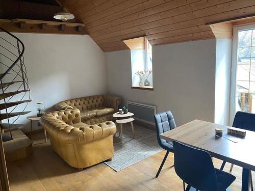 a living room with a couch and a table at Appartement cœur vallée d'Aure in Vielle-Aure