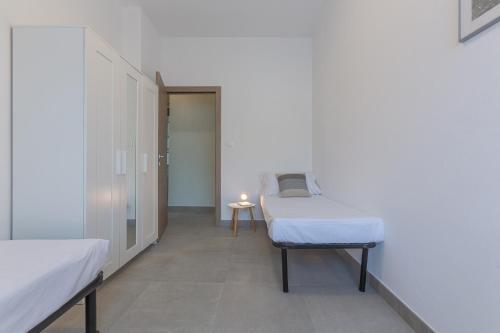 a hospital room with two beds and a table at Ferrara Biscay Bay Apartment with balconies in Ferrara