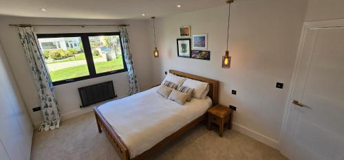 a bedroom with a large bed with a window at Beachside luxury in Newquay