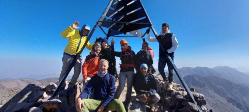 a group of people standing on the top of a mountain at Oussaya House in Imlil