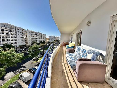 a balcony with couches and a view of a city at Rei Apartment in Quarteira