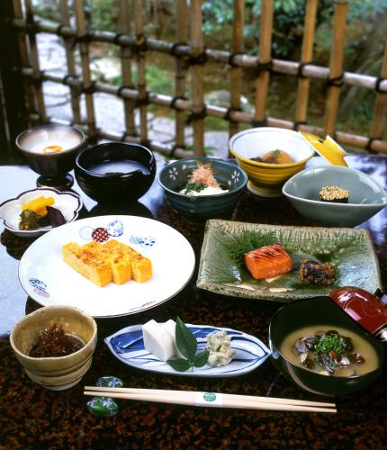 a table topped with bowls and plates of food at Gyokutei in Hakone