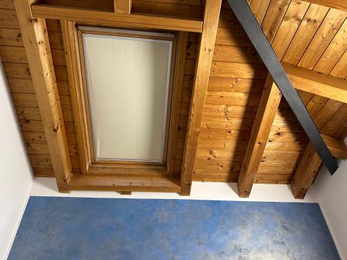 a room with a window in a wooden attic at Casa Rondinella in Negrar
