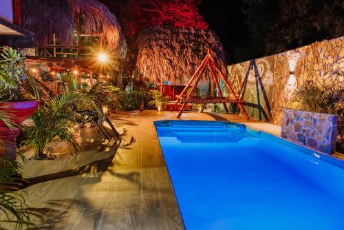 a swimming pool in a room with plants at Kasakolà in Palomino