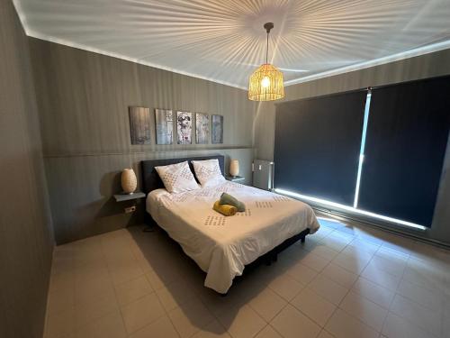 a bedroom with a bed and a chandelier at Maurice en ville n14 in Namur