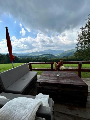 a patio with a couch and a table with a view at Magiczne Wzgórze in Ustroń