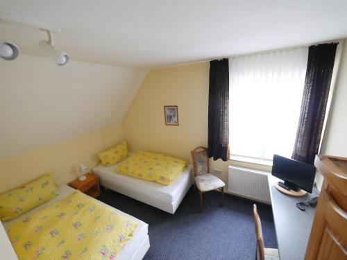 a room with two beds and a window at TM Hotel Westfalen in Lünen