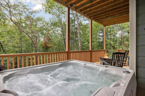 a jacuzzi tub on the back of a house at Chasing the Son Cabin cabin in Sevierville