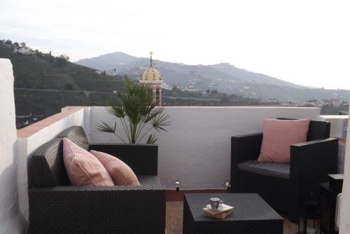 孔佩塔的住宿－Casa Elvira，阳台配有2把椅子和1张桌子,享有风景。