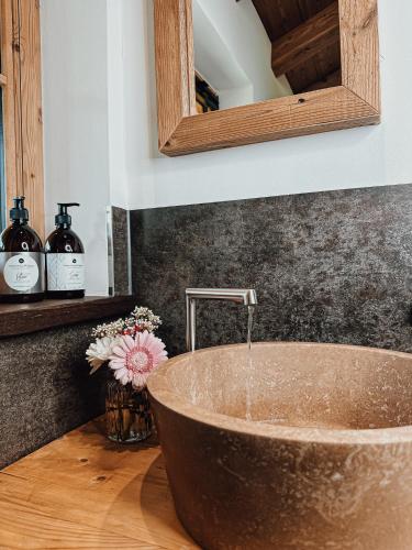 a bathroom with a copper sink with water coming out of it at Chalet Nordic mit privatem Whirlpool und Sauna in Bayrischzell