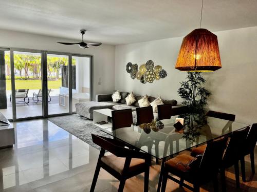 a living room with a glass table and a couch at Mareazul Beachfront Resort - Casa Ancora in Playa del Carmen