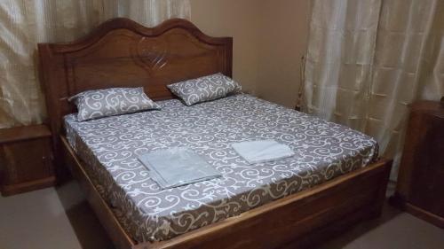 a bed with two pillows on top of it at Annex House For Rent in Manjai Kunda