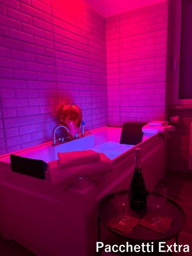 a pink bathroom with a tub with a sink at Guest House Il Faraone in Fiumicino