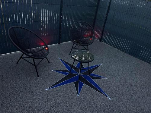 two chairs and a star sculpture on the floor at Chambre romantique avec Spa B in Gruny