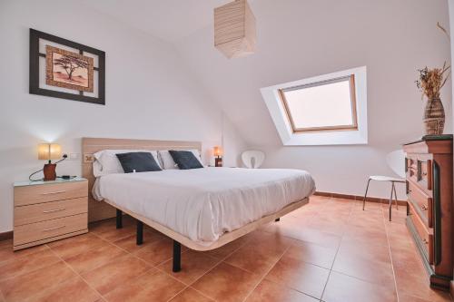 a bedroom with a large bed and a window at Palmeira Vistamar by Serendipia Turismo in San Pedro