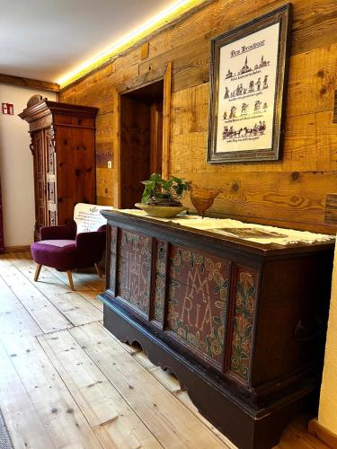 a room with a wooden wall with a painting on it at Unterlettlhof in Saalfelden am Steinernen Meer