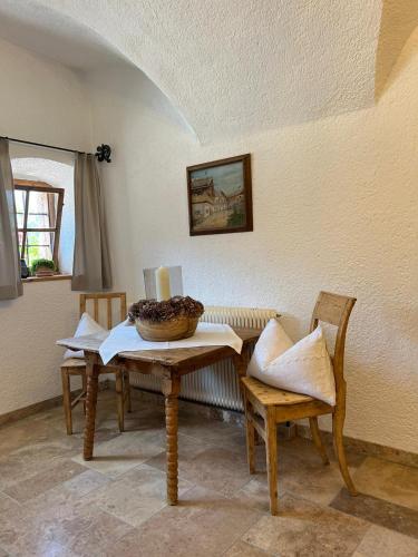 a dining room with a table and two chairs at Unterlettlhof in Saalfelden am Steinernen Meer